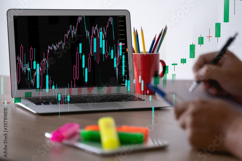 man Analyzing data graphs and reports investor with computer and tradeview graph Finance Stock Exchange finance traders photo