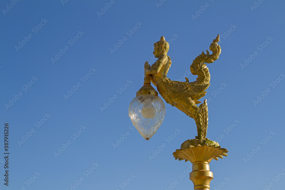 Gold lamps and lighting pole background with a blue sky,at Wat Ban Ngao (Temple), Ranong, Thailand. Gold lamps and lighting pole background with a blue sky,at Wat Ban Ngao (Temple), Ranong, Thailand.