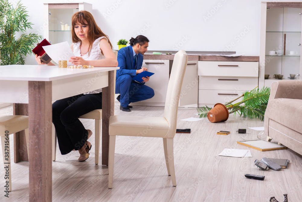 Female owner and male police officer in housebreaking concept Female owner and male police officer in housebreaking concept