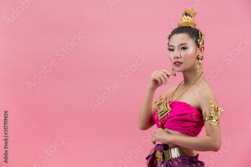 Loy Krathong Festival;woman in thai traditional outfit holding decorated buoyant