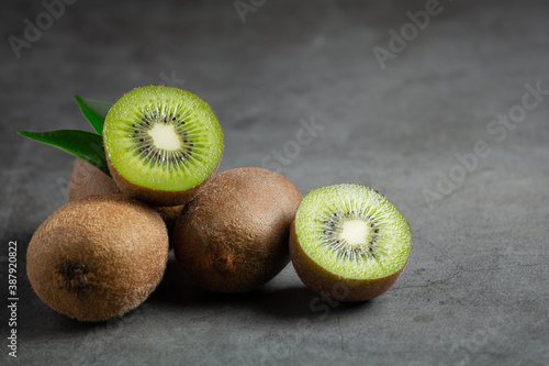 Fresh kiwi, cut into half, put on dark floor