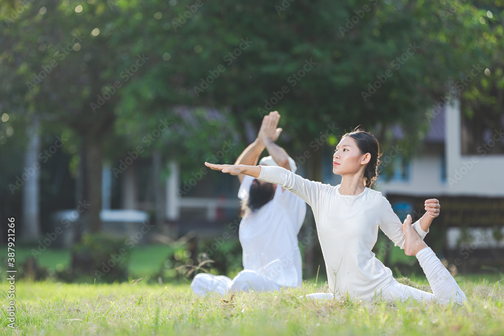 two people in white outfit doing yoga in nature two people in white outfit doing yoga in nature