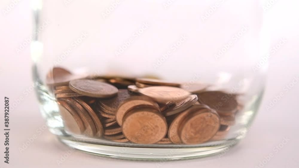 Coins falling into jar - slow motion Coins falling into jar - slow motion