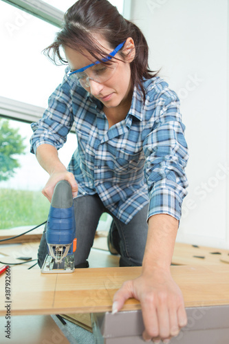 portrait of woman cutting woodboards photo