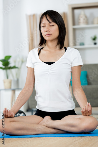 young woman practicing yoga in lotus pose Free Download young woman practicing yoga in lotus pose - GFXLoad