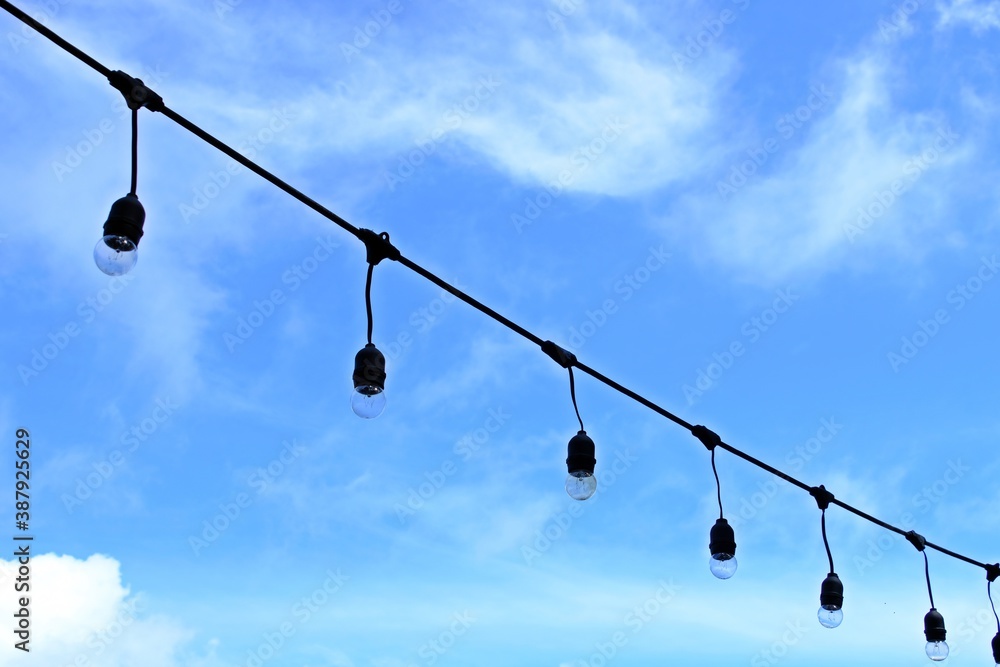Globe string light bulbs with blue sky background. Globe string light bulbs with blue sky background.