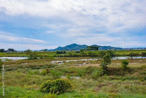 mountain, river and plain under a cloudy sky