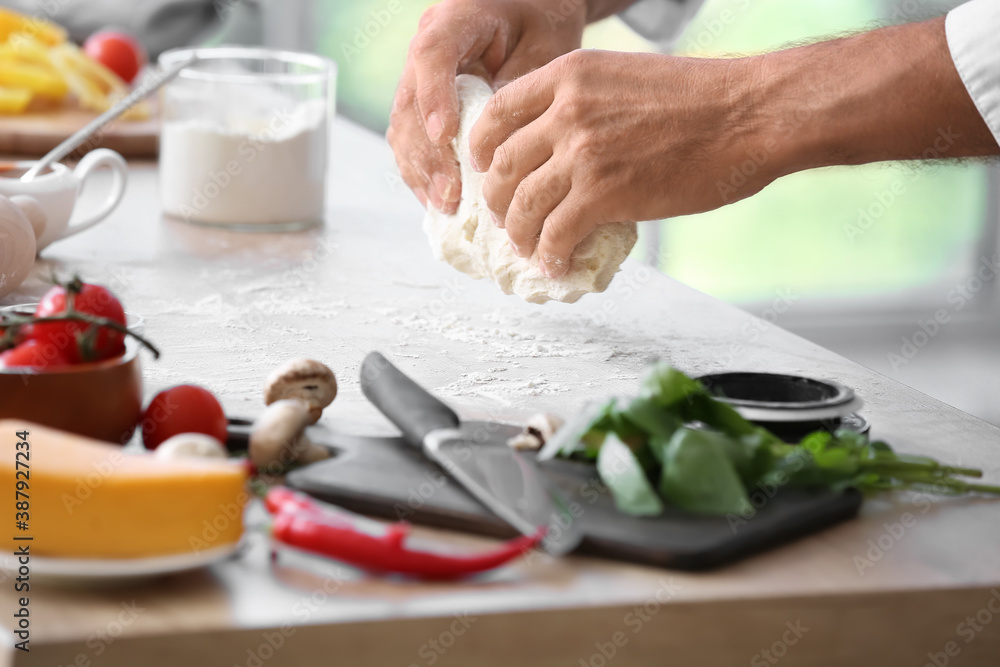 Mature chef cooking in kitchen, closeup