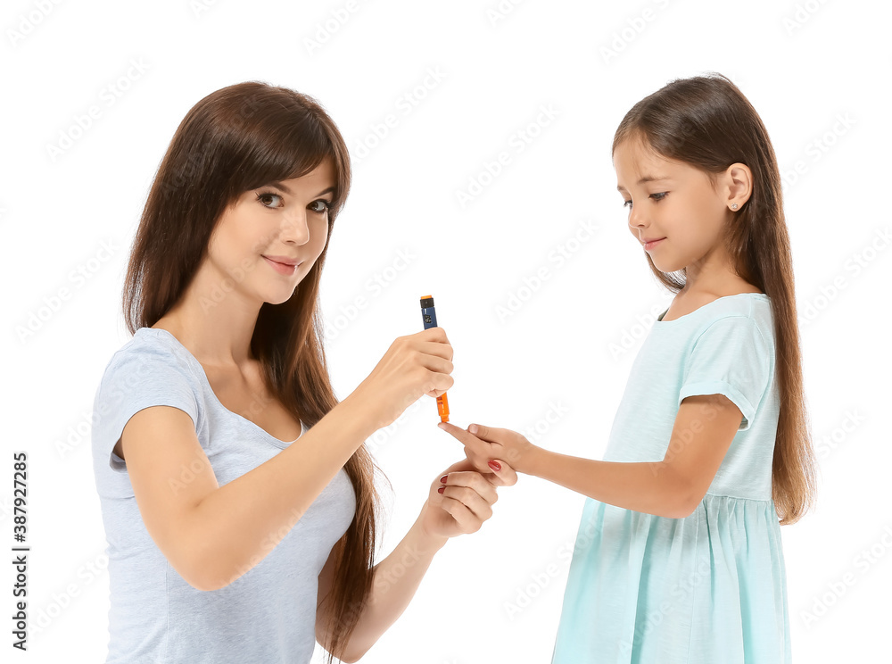 Mother taking blood sample of diabetic daughter on white background Mother taking blood sample of diabetic daughter on white background