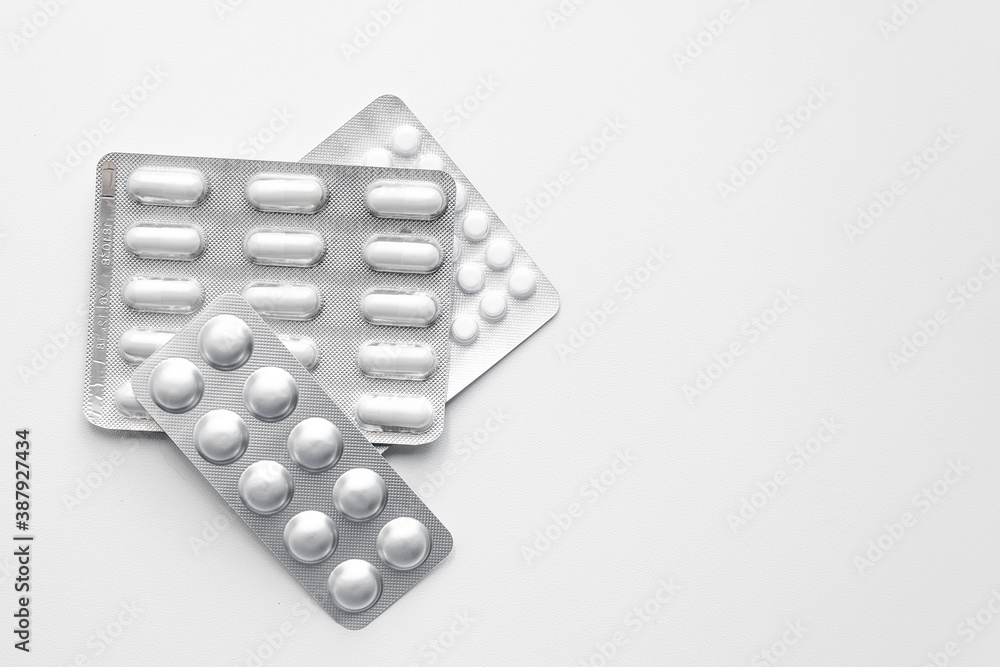pack of pills lying on a white table pack of pills lying on a white table