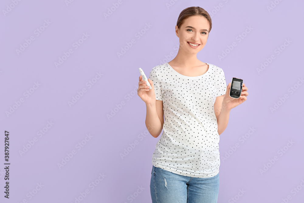 Pregnant diabetic woman with digital glucometer and lancet pen on color background Pregnant diabetic woman with digital glucometer and lancet pen on color background