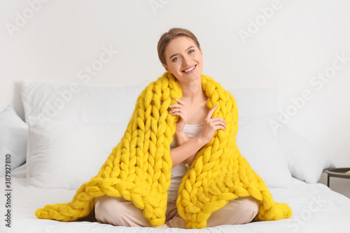 Happy young woman with warm...