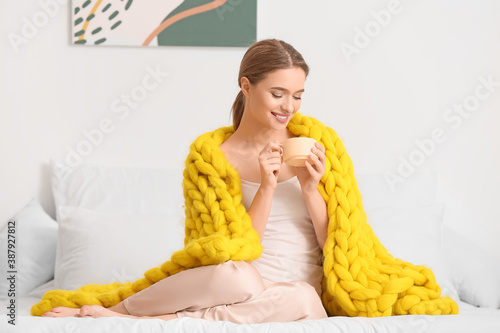 Happy young woman with warm...