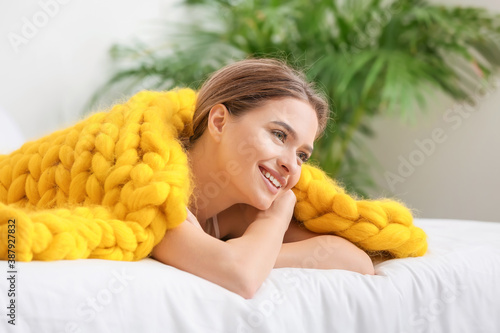 Happy young woman with warm...