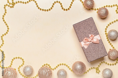 Frame made of beautiful Christmas gift box and decor on color background