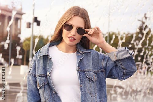 Beautiful woman with stylish sunglasses outdoors © Pixel-Shot