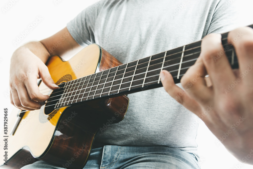 Close-up of guitarist hand playing on classical guitar