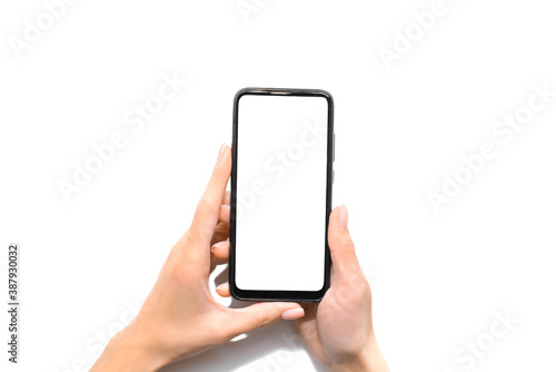Woman holds a phone with a blank white screen in her hands. Place for your text, message, information. Isolated on white background