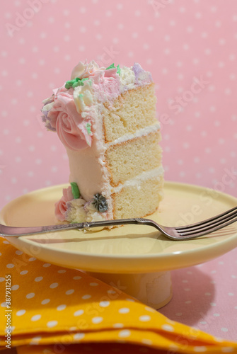 Floral frosted layer cake on pink background
