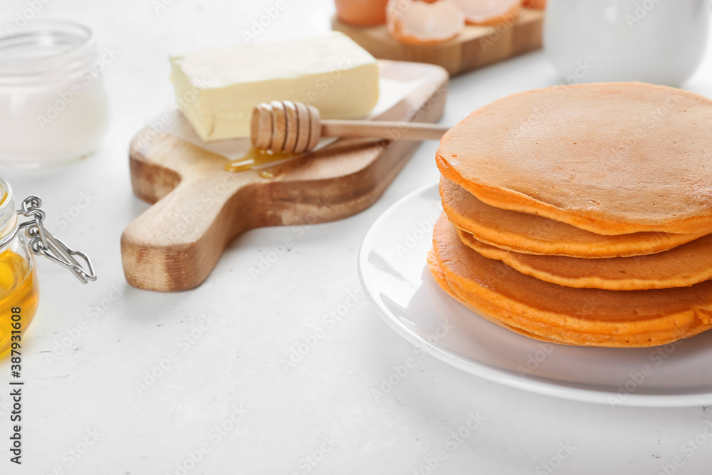 Tasty pumpkin pancakes with ingredients on table - obrazy, fototapety, plakaty 