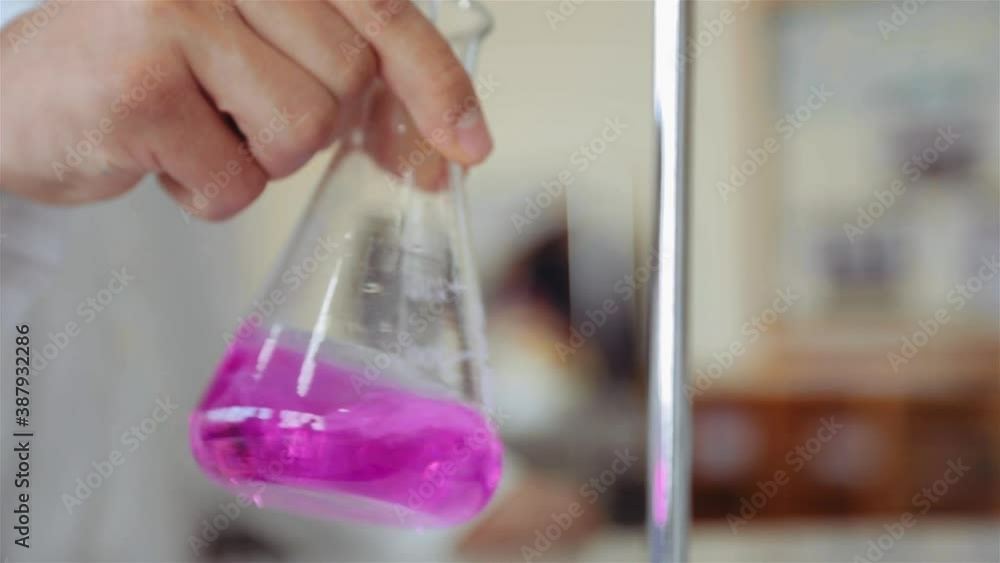Scientist Mixing Titrant And Analyte In An Erlenmeyer Flask (Conical