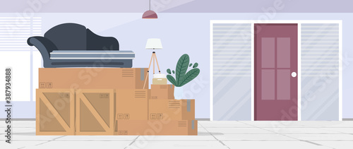 Moving home banner. Moving to a new place. Wooden boxes, cardboard boxes, sofa, houseplant, floor lamp. Vector. © Javvani