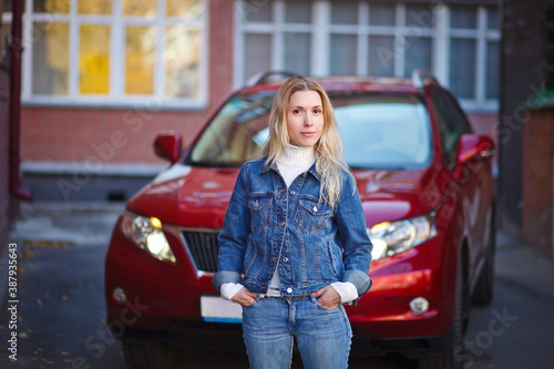 Fototapeta beautiful girl near red car, businesswoman