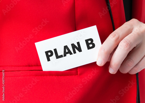 Businessman put card with text PLAN B in pocket, close-up. Business concept.