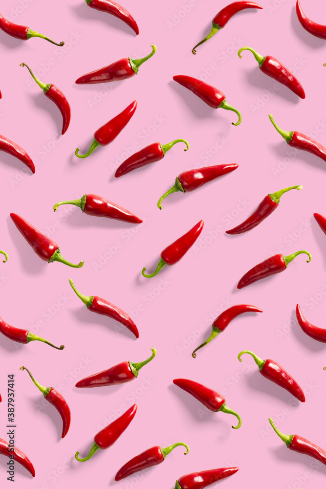 Creative background made of red chili or chilli on pink backdrop. Minimal food backgroud. Red hot chilli peppers background. Creative background made of red chili or chilli on pink backdrop. Minimal food backgroud. Red hot chilli peppers background.