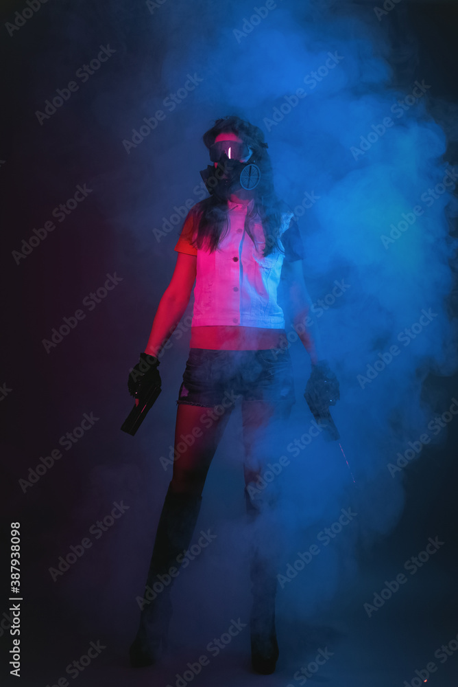 Girl with a toy guns in hands in the smoke. Cyberpunk concept.