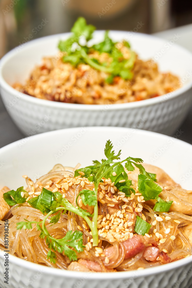 Cellophane noodles with chicken and bacon in a light plate Cellophane noodles with chicken and bacon in a light plate