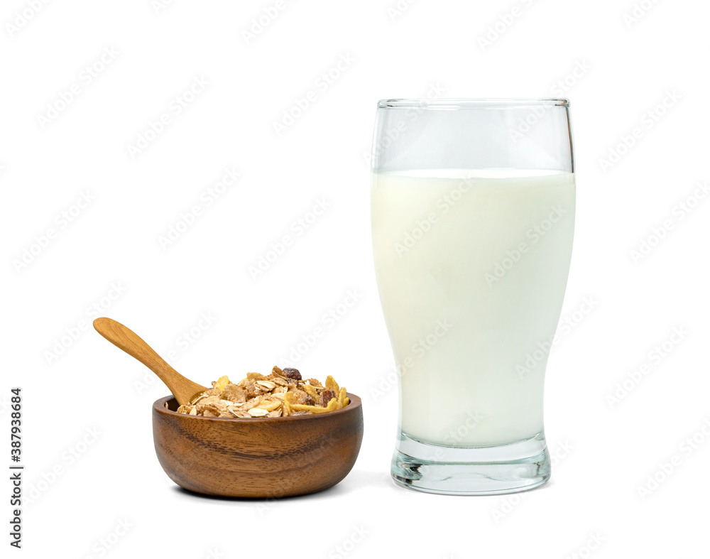 milk in transparent glass and muesli multi fruit in wooden bowl and spoon isolated on white background ,include clipping path milk in transparent glass and muesli multi fruit in wooden bowl and spoon isolated on white background ,include clipping path