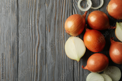 Fresh onion on wooden background, top view