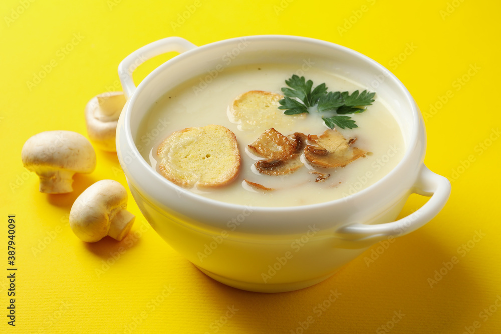 Bowl of tasty mushroom soup on yellow background Bowl of tasty mushroom soup on yellow background