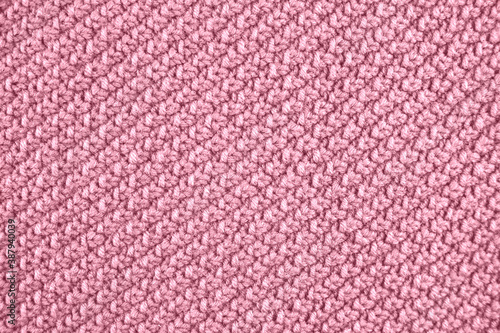 Knitted texture in pink color. Close up.