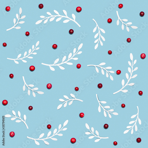 Winter seamless pattern: red cranberries with white paper crafted twigs with leaves
