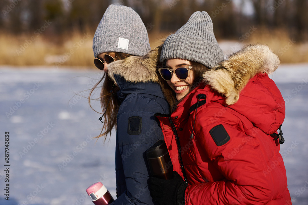A trendy young girls walk and have a fun outdoor in winter A trendy young girls walk and have a fun outdoor in winter