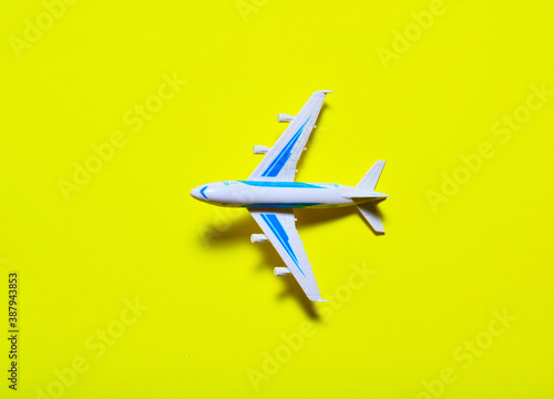 taking off toy plane on a yellow background. the concept of a business trip, a flight on vacation, a vacation in warm regions.