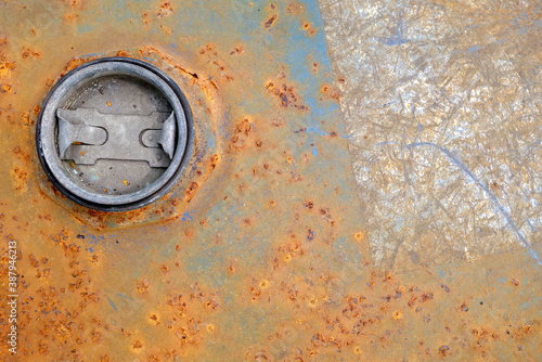 round lid on rusty grunge metal texture of fuel tank or liquid chemical