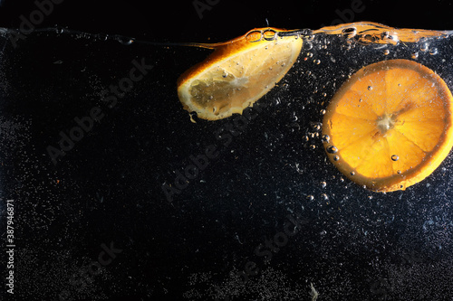 Water drops on ripe sweet orange. Fresh mandarin background with copy space for your text. Vegetarian concept. photo