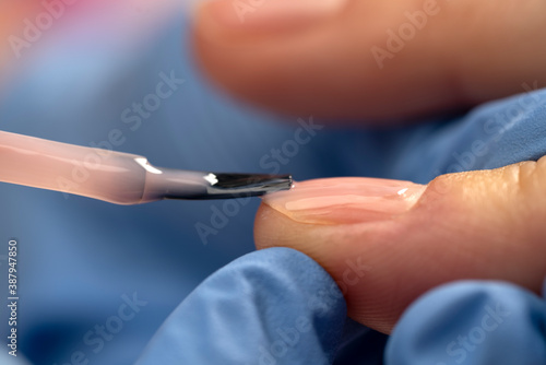 Woman's nail being manicured, polished, closeup.