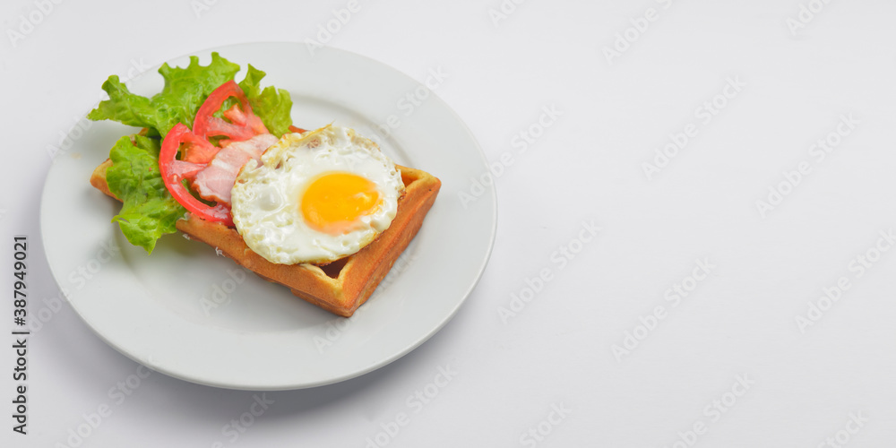 Close up of rustic savory bacon and egg waffle. Traditional breakfast idea. Egg toast for breakfast. Close up of rustic savory bacon and egg waffle. Traditional breakfast idea. Egg toast for breakfast.