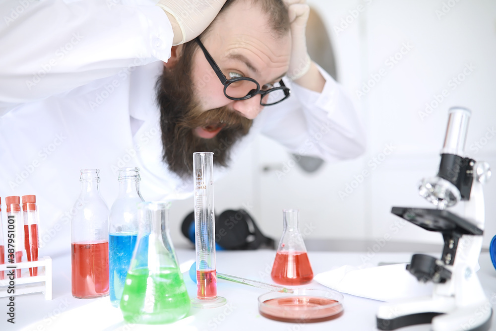 Chemist crazy. A mad scientist conducts experiments in a scientific laboratory. Performs research using a microscope. Chemist crazy. A mad scientist conducts experiments in a scientific laboratory. Performs research using a microscope.