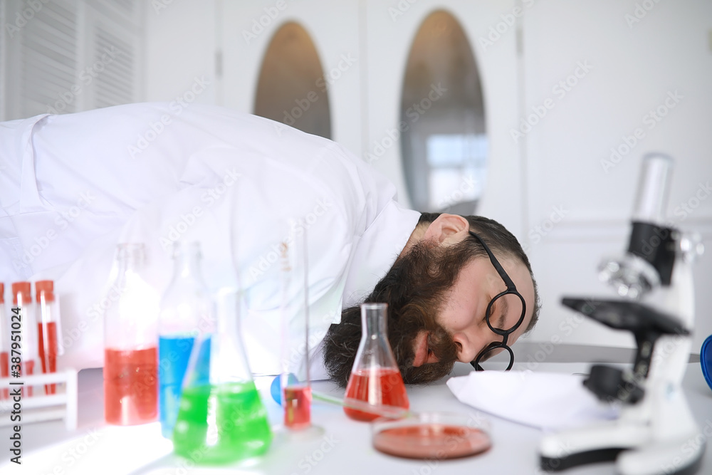 Chemist crazy. A mad scientist conducts experiments in a scientific laboratory. Performs research using a microscope. Chemist crazy. A mad scientist conducts experiments in a scientific laboratory. Performs research using a microscope.