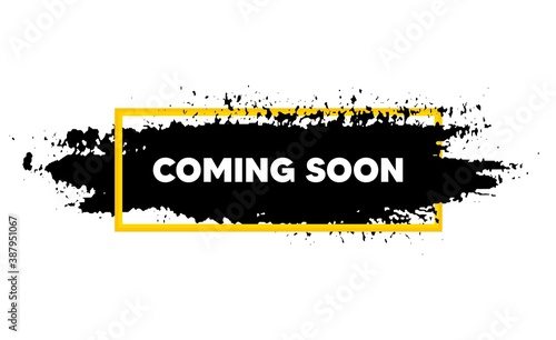 Coming soon. Paint brush stroke in box frame. Promotion banner sign. New product release symbol. Paint brush ink splash banner. Coming soon badge shape. Grunge black watercolor banner. Vector photo