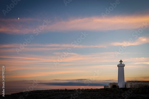 The lighthouse and the moon at sunset