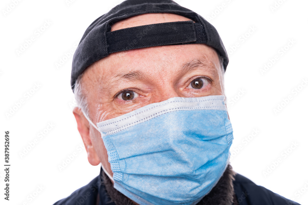Senior man in protective mask posing in studio over white background Senior man in protective mask posing in studio over white background
