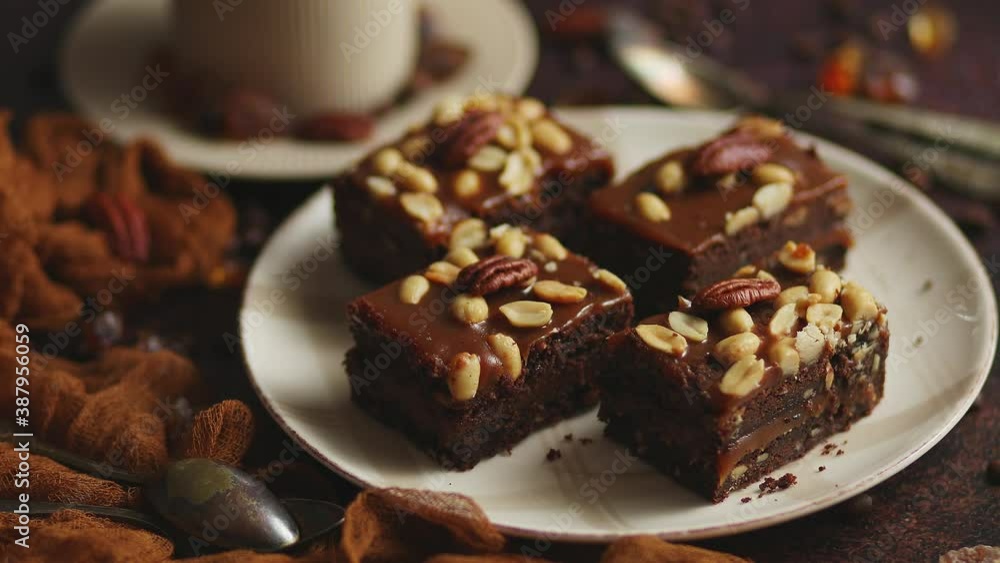 Chocolate cake with caramel frosting, pecans and hot coffee, on rustic background. Freshly baked Chocolate cake with caramel frosting, pecans and hot coffee, on rustic background. Freshly baked