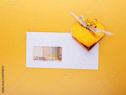 Money for present concept with euro banknotes in envelope and gift box