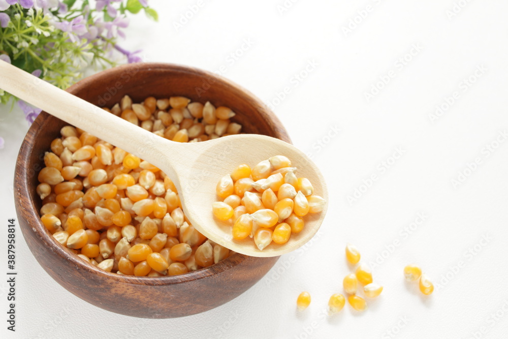 dried pop corn grain in wooden bowl with spoon for cooking ingredient dried pop corn grain in wooden bowl with spoon for cooking ingredient